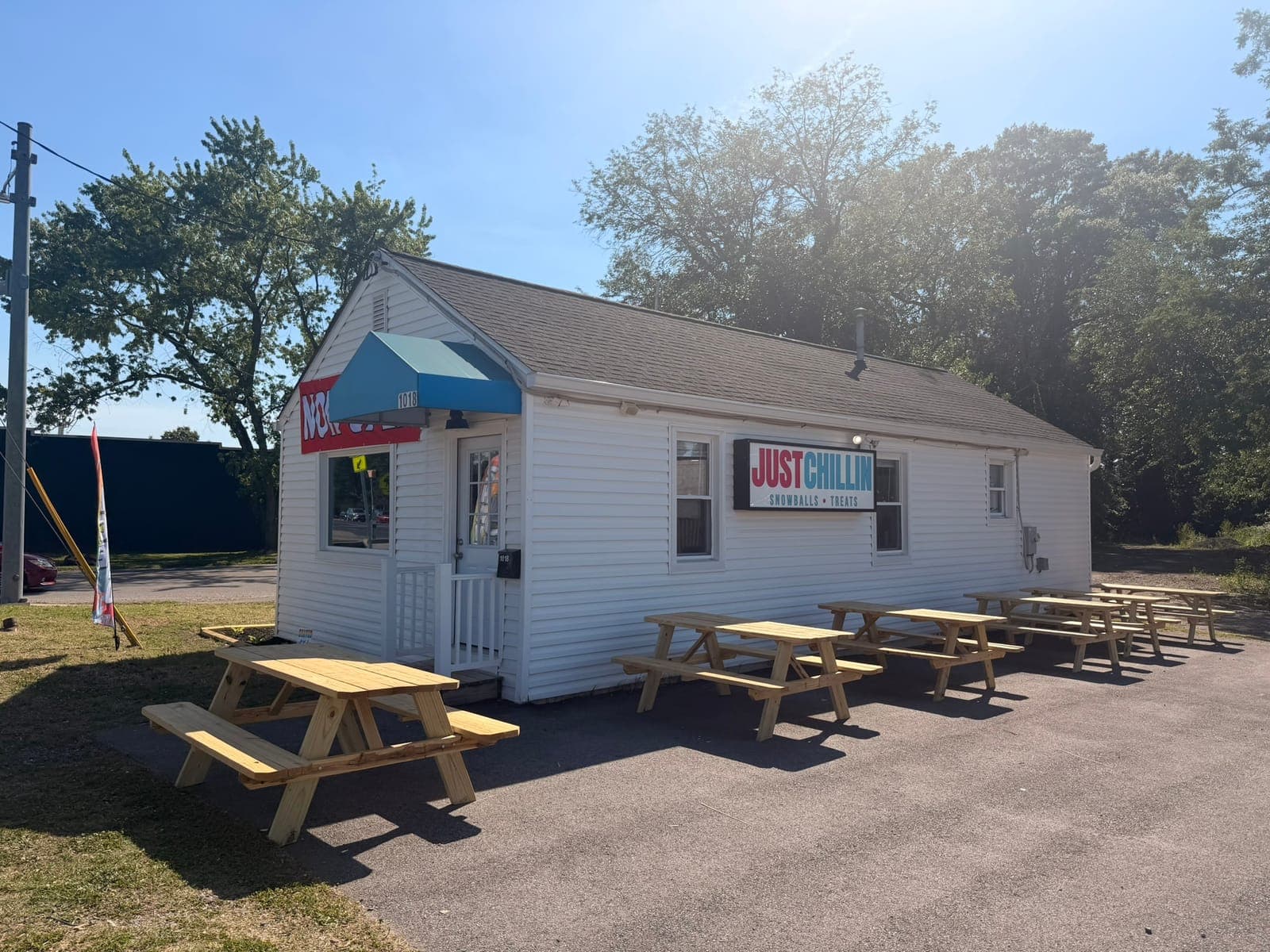 Picnic tables lined up outside the Just Chillin' building on Crain Highway
